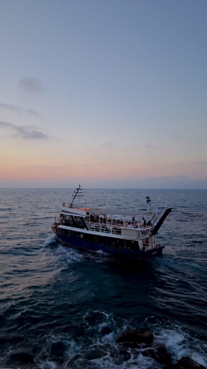 A party boat off Jaffa at dusk, drone view